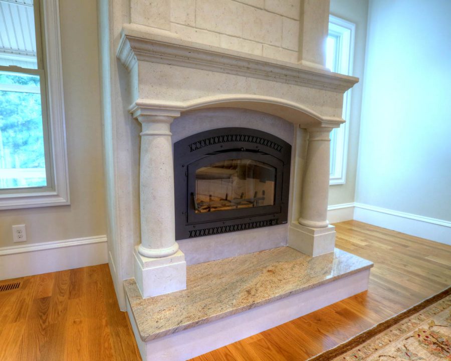 cast stone fireplace mantel featuring tuscan columns